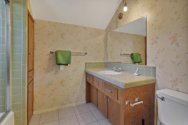 full bathroom featuring tile patterned floors, toilet, vaulted ceiling, vanity, and enclosed tub / shower combo