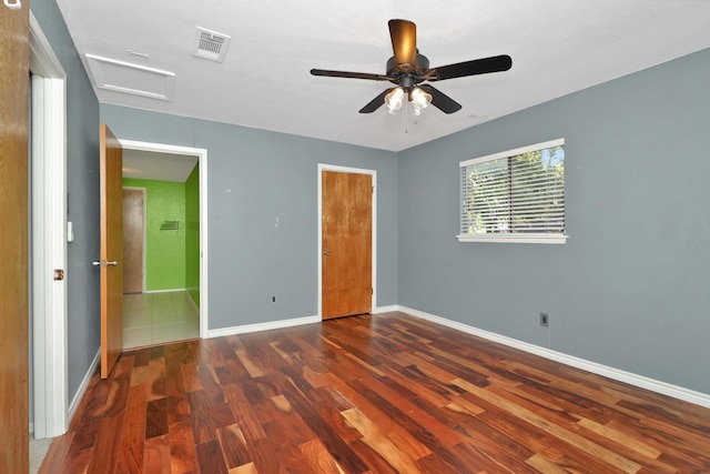 unfurnished bedroom with ceiling fan and dark hardwood / wood-style flooring