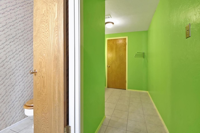 hall featuring light tile patterned floors