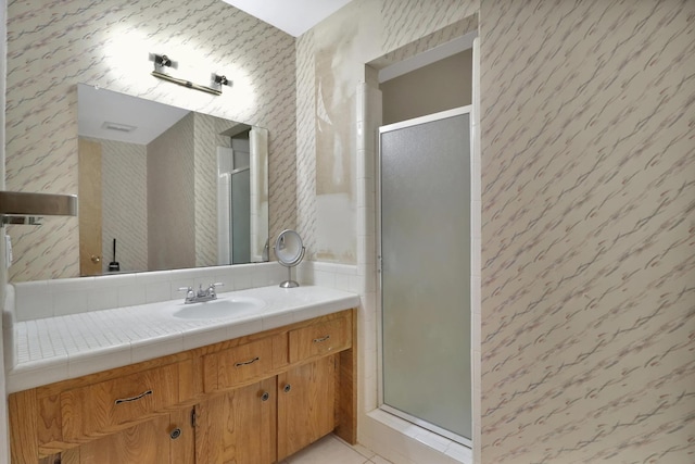 bathroom with vanity, an enclosed shower, and tile patterned floors