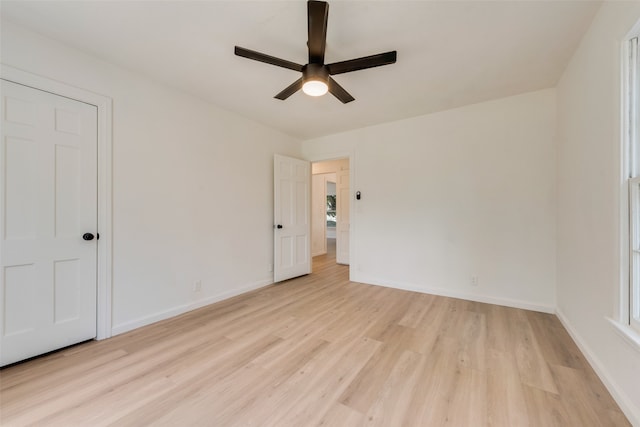 unfurnished bedroom with light hardwood / wood-style flooring, multiple windows, and ceiling fan