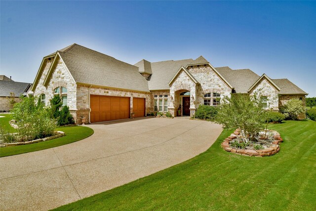 french country home featuring a front yard