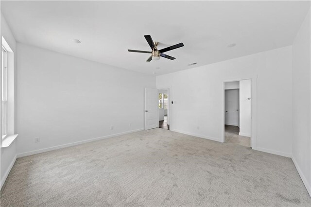 carpeted spare room with ceiling fan