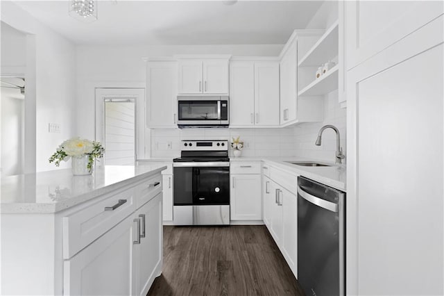 kitchen featuring appliances with stainless steel finishes, sink, dark hardwood / wood-style floors, and white cabinets