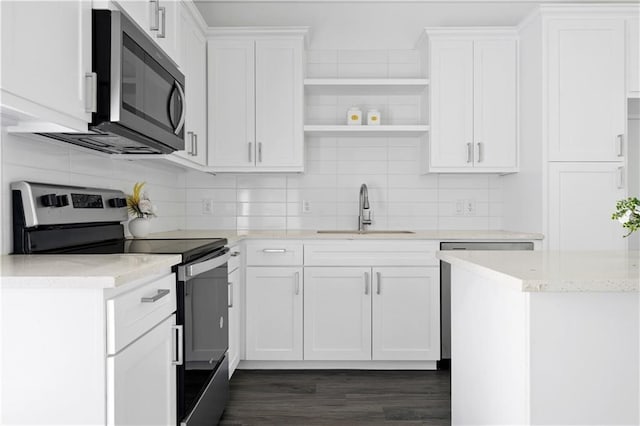 kitchen with dark hardwood / wood-style flooring, stainless steel appliances, white cabinetry, and sink