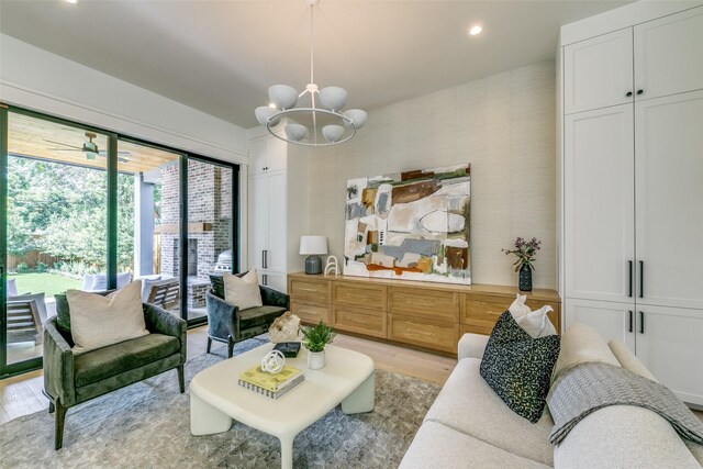 living room featuring light hardwood / wood-style floors and a chandelier