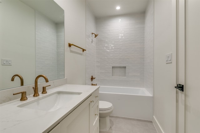 full bathroom featuring tile patterned floors, vanity, tiled shower / bath, and toilet