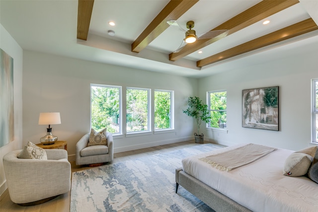 bedroom with beamed ceiling, ceiling fan, and light hardwood / wood-style floors