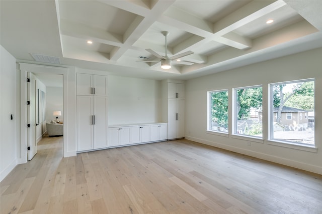 unfurnished bedroom featuring multiple windows, coffered ceiling, and light wood-type flooring