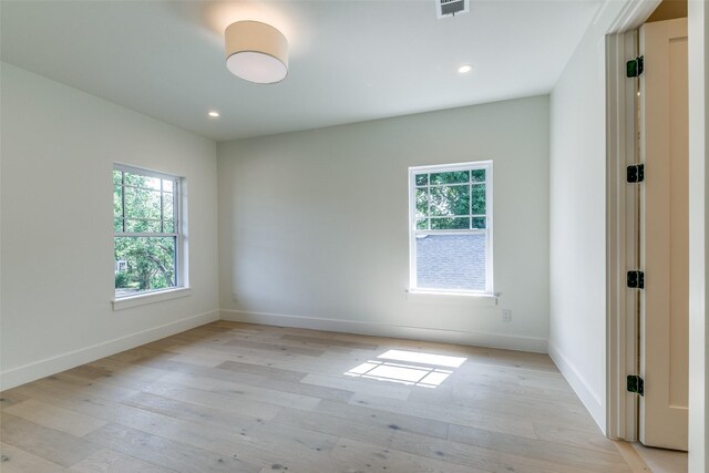 empty room with light hardwood / wood-style flooring