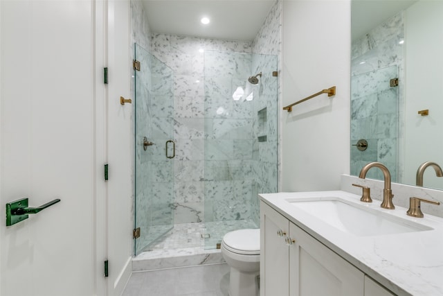 bathroom featuring tile patterned floors, vanity, an enclosed shower, and toilet