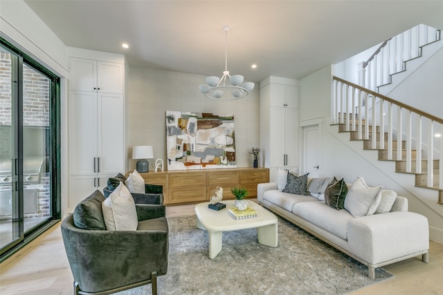 living room with light hardwood / wood-style floors and a chandelier