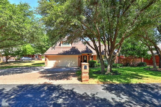 front facade featuring a front yard and a garage