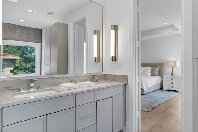 bathroom featuring hardwood / wood-style flooring and double vanity