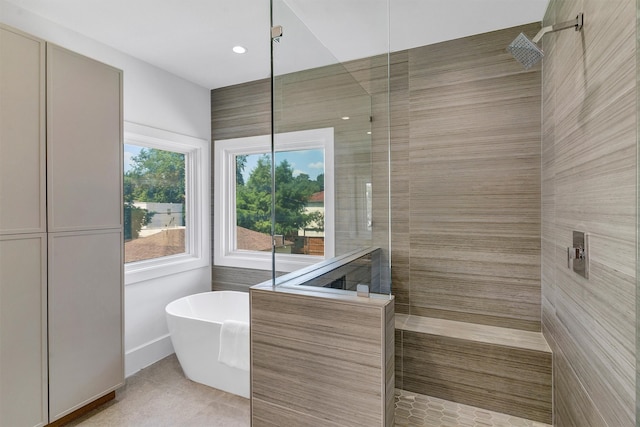 bathroom with tile patterned floors and independent shower and bath