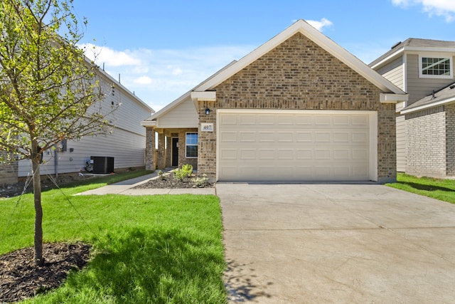 view of front facade with a front yard, cooling unit, and a garage