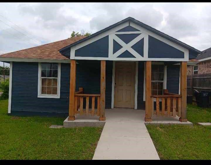 exterior space featuring covered porch and a lawn