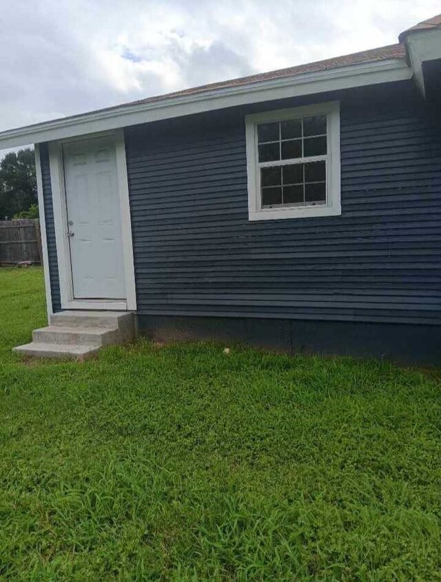 view of side of home with a lawn