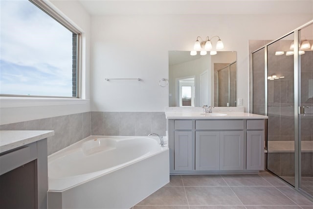 bathroom featuring independent shower and bath, vanity, tile patterned floors, and plenty of natural light