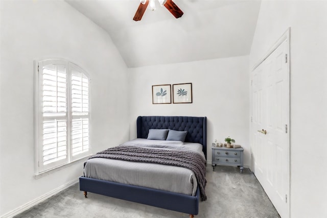 carpeted bedroom featuring multiple windows, ceiling fan, and lofted ceiling