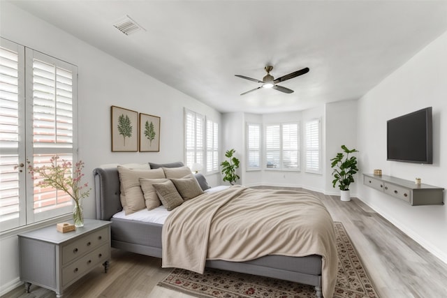 bedroom with ceiling fan and light wood-type flooring