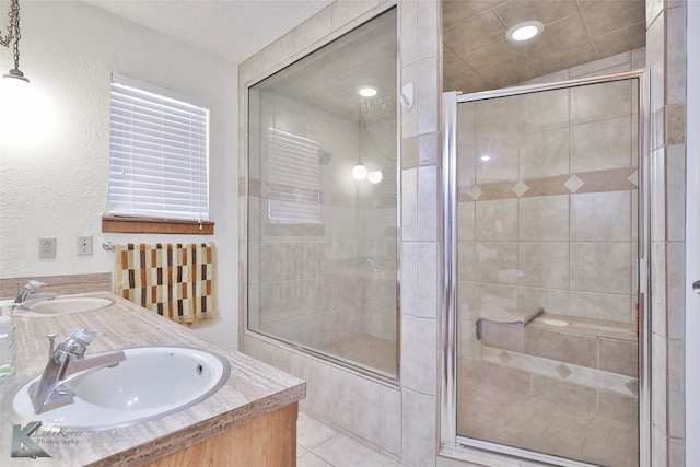 bathroom with an enclosed shower and double sink vanity