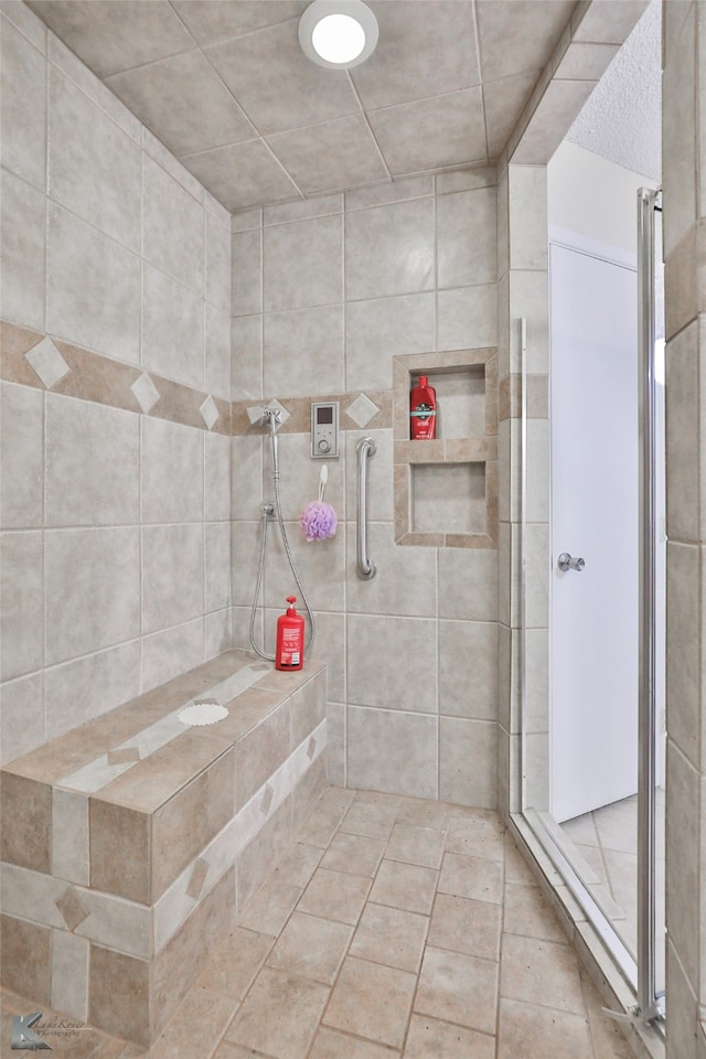 bathroom with a shower with door