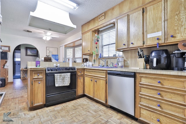 kitchen with light parquet floors, dishwasher, kitchen peninsula, and black electric range