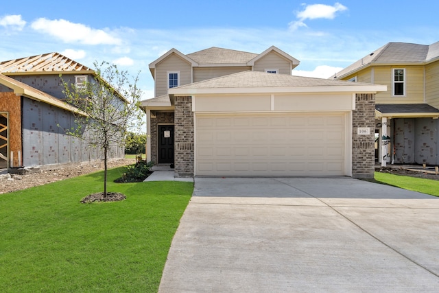 view of front of home with a front yard and a garage