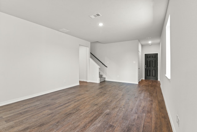 unfurnished living room with dark hardwood / wood-style flooring