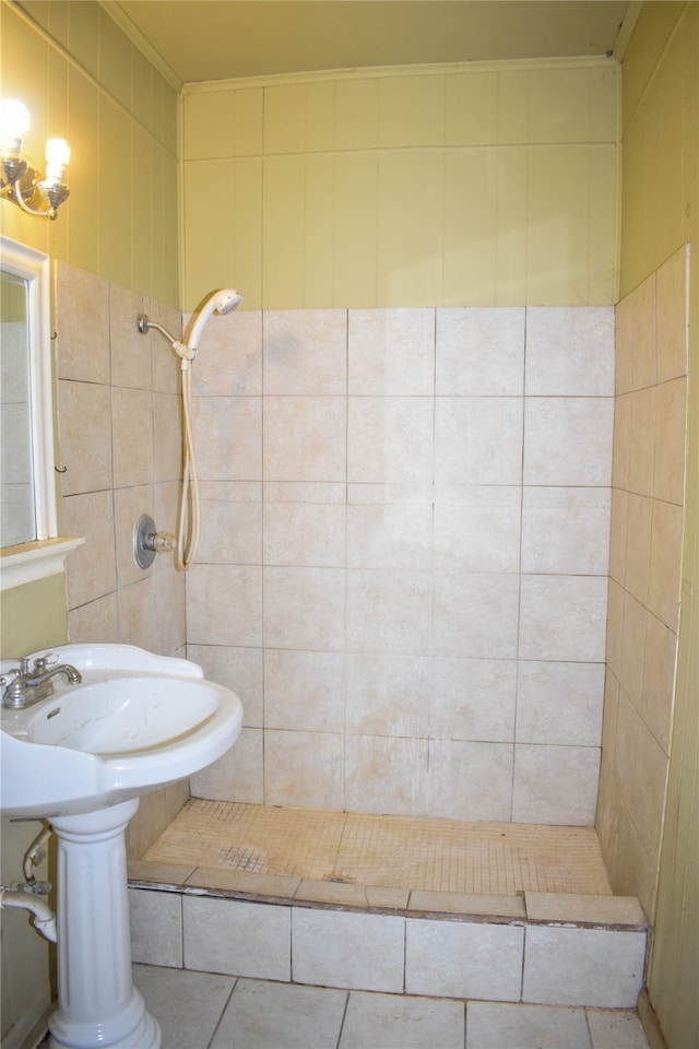 bathroom with tiled shower, tile patterned flooring, and tile walls