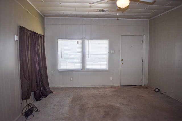 carpeted spare room with ceiling fan