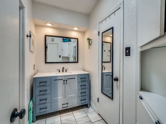 bathroom with tile patterned flooring and vanity