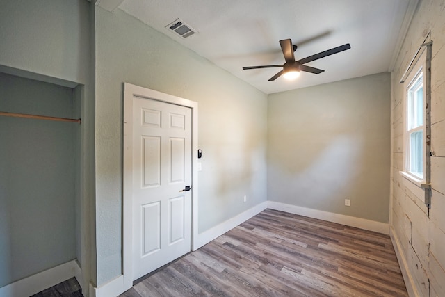 unfurnished bedroom with hardwood / wood-style flooring and ceiling fan