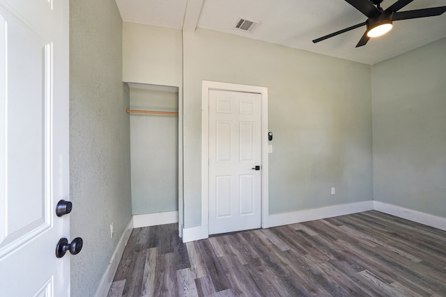 unfurnished bedroom with dark wood-type flooring and ceiling fan