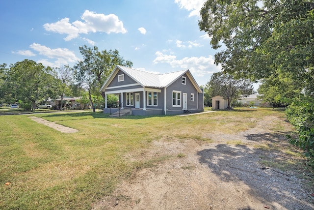 view of front of home featuring covered porch and a front lawn