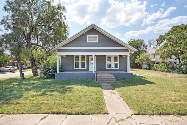 bungalow featuring a porch and a front lawn