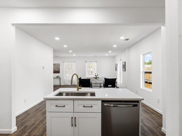 kitchen with sink, dishwasher, dark hardwood / wood-style floors, and a kitchen island with sink