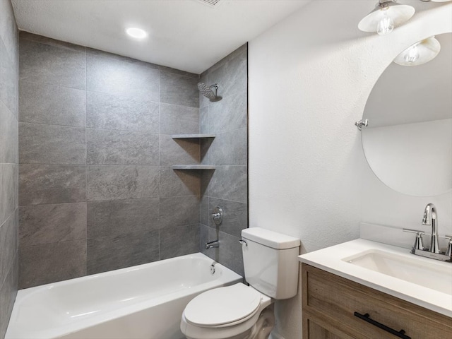 full bathroom featuring tiled shower / bath combo, vanity, and toilet