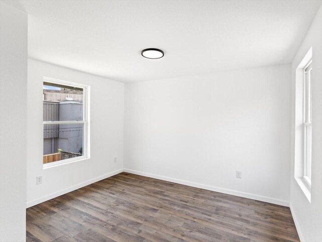 spare room with dark hardwood / wood-style flooring