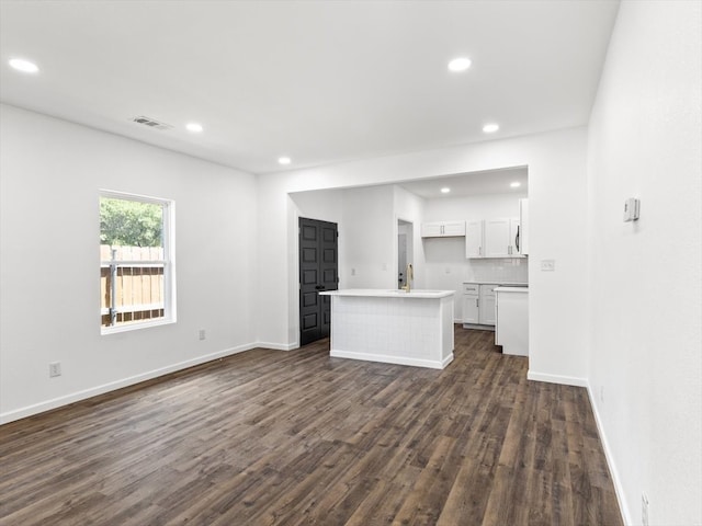 unfurnished living room with dark hardwood / wood-style floors