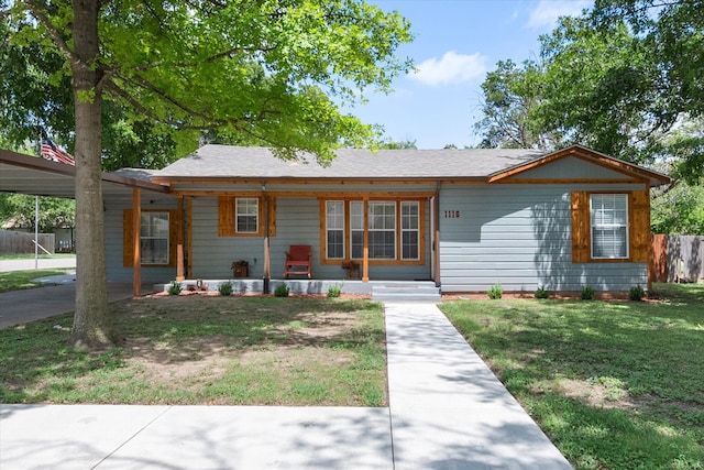 ranch-style home featuring a carport and a front yard