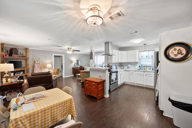 kitchen featuring dark hardwood / wood-style floors, white cabinets, stainless steel range with electric stovetop, range hood, and ceiling fan