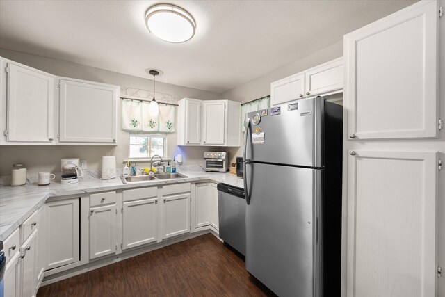 kitchen with white cabinets, sink, stainless steel appliances, and dark hardwood / wood-style floors