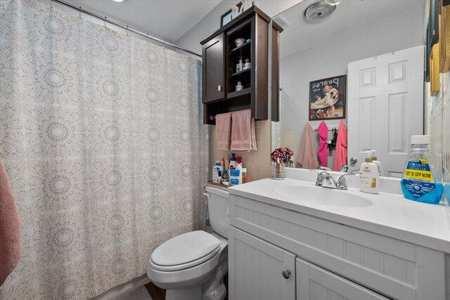 bathroom featuring toilet and vanity