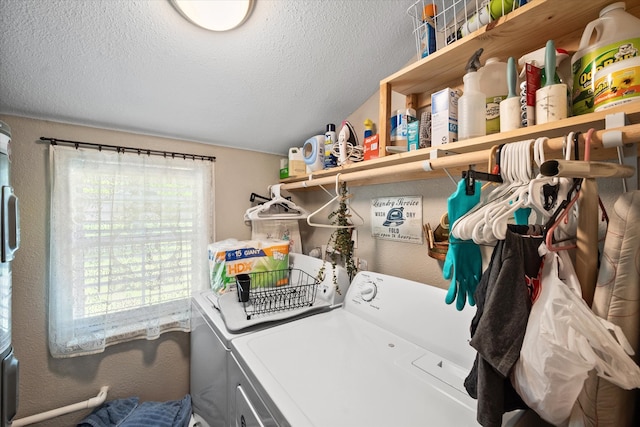 laundry area featuring a textured ceiling and washer and dryer