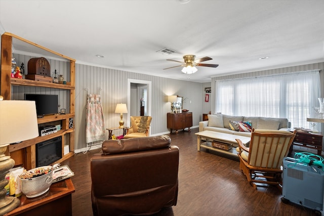 living room with dark hardwood / wood-style flooring and ceiling fan