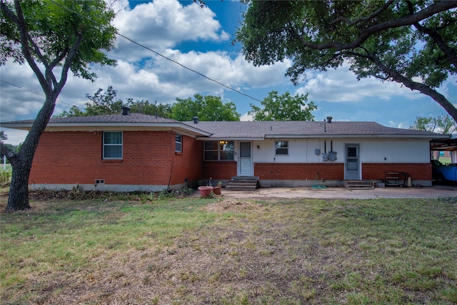 rear view of property featuring a yard