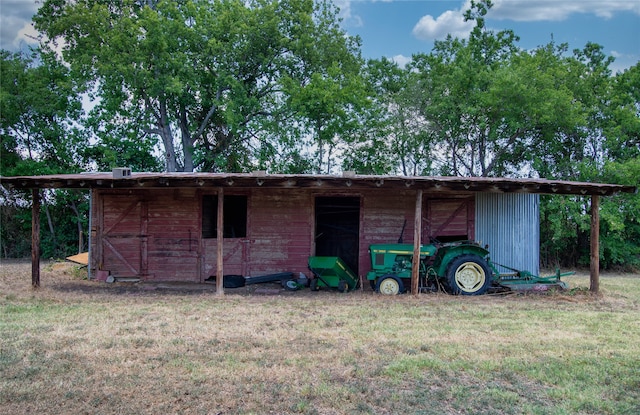 view of outdoor structure featuring a lawn