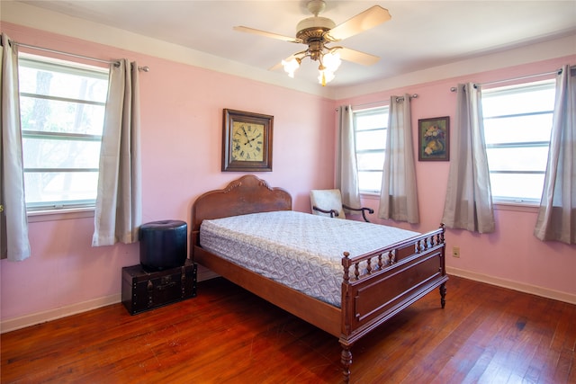 bedroom with ceiling fan and dark hardwood / wood-style flooring